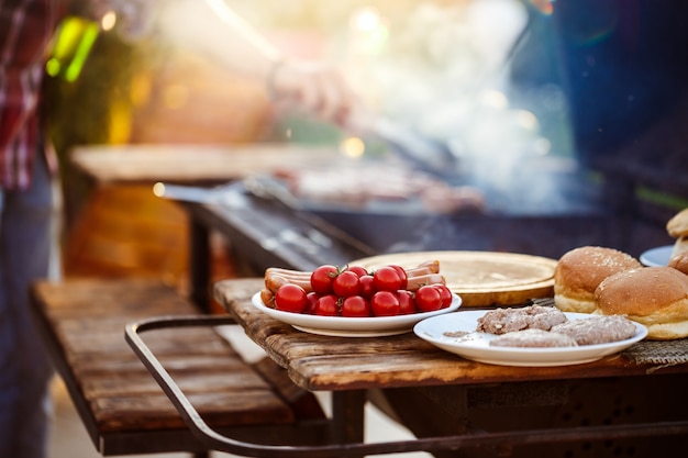 Free photo young man roasting barbecue on grill. focus on food.