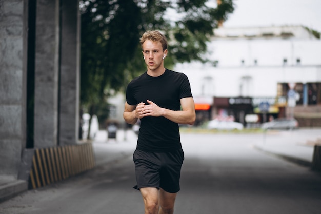 Free photo young man running in the city in the morning