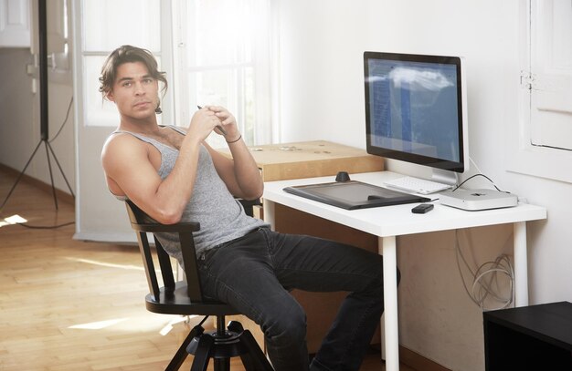 Young man seat on his workplace cosy apartment