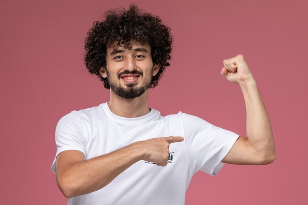 young man shows his tiny biceps