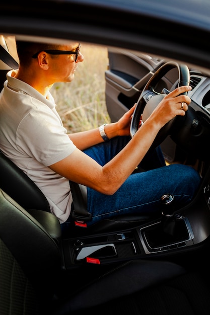 Young man siting at the steering wheel