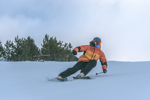 Young man skiing in the Pyrenees at the Grandvalira ski resort