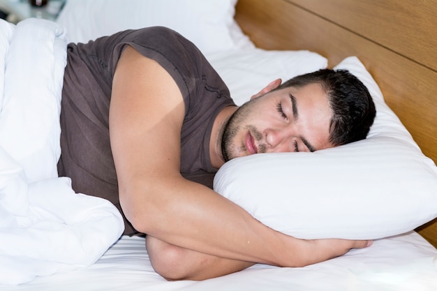 Young man sleeping in his bed