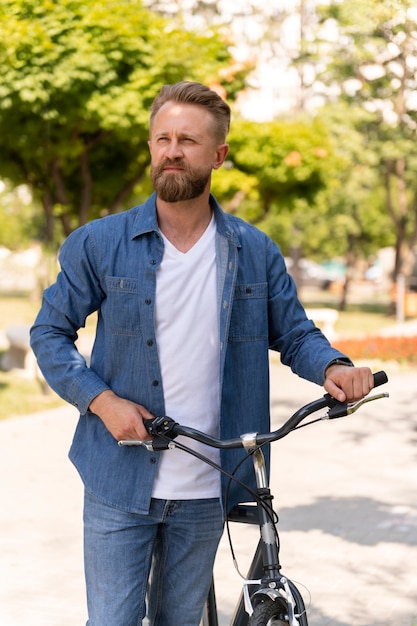 Young man spending time outside with his bike