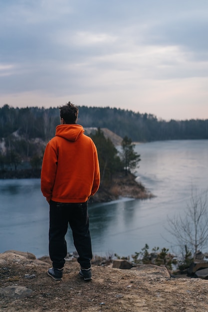 A young man standing on the edge of a cliff 