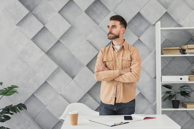 Free photo young man standing in an office