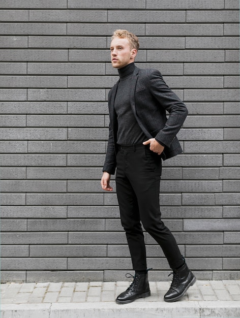 Young man on the street with one hand in his pocket