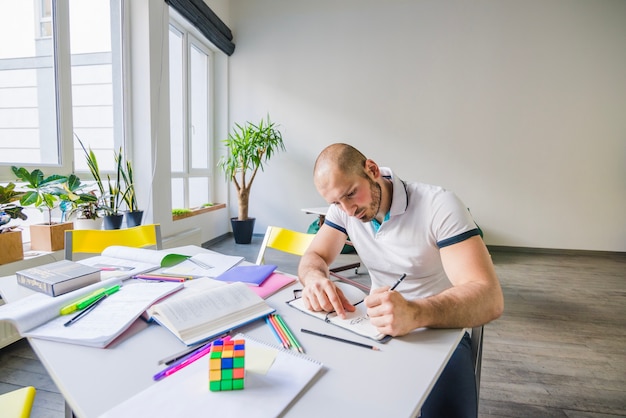 Young man studying alone in room