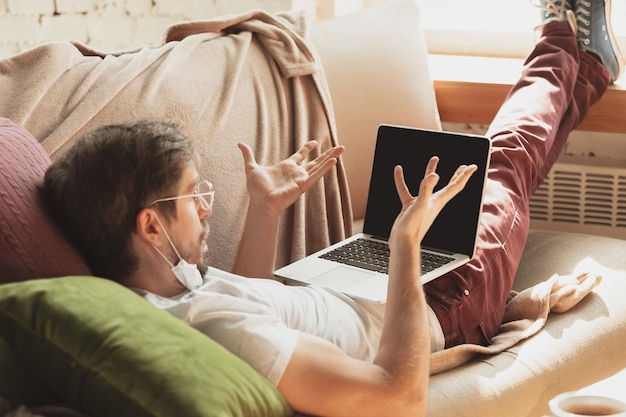 Free photo young man studying at home during online courses for journalist, critics, writers.