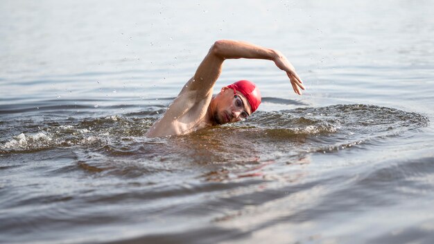 Young man swimming in lake