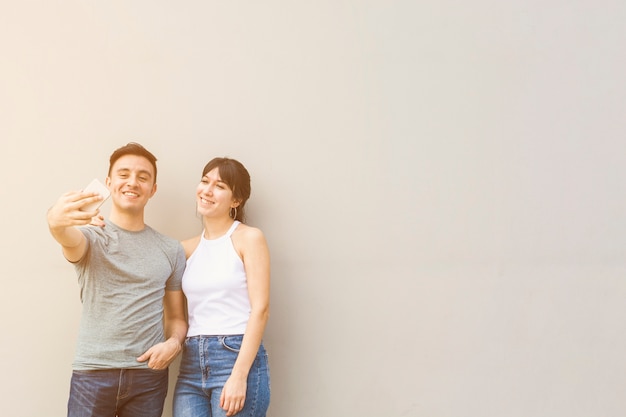 Young man taking a selfie with woman