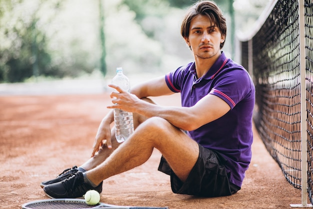 Young man tennis player at the court