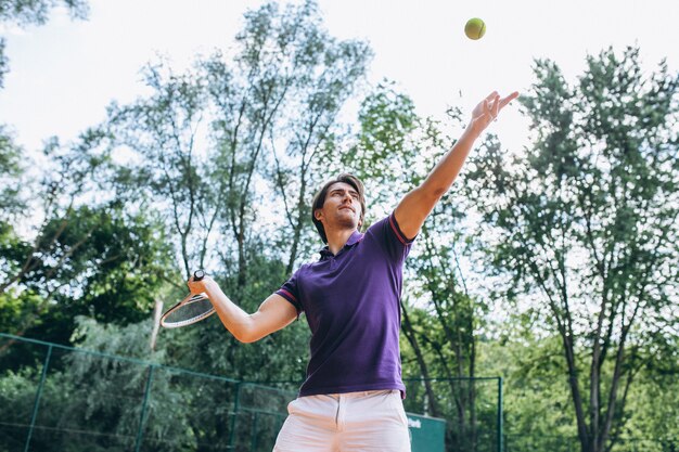 Young man tennis player at the court