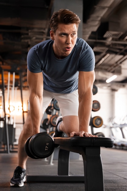 Young man training at the gym for bodybuilding