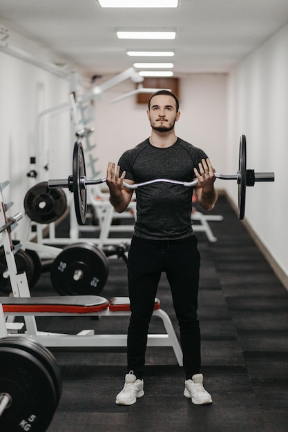 Young man trains his body to stay fit and have defined muscles