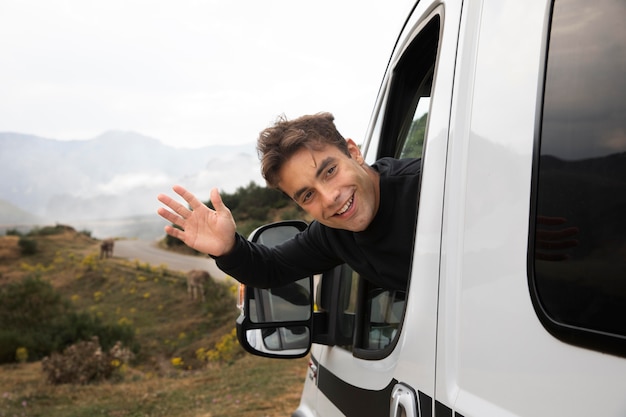 Young man traveling alone in a van