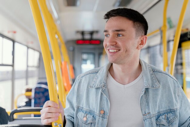 Young man travelling by city bus