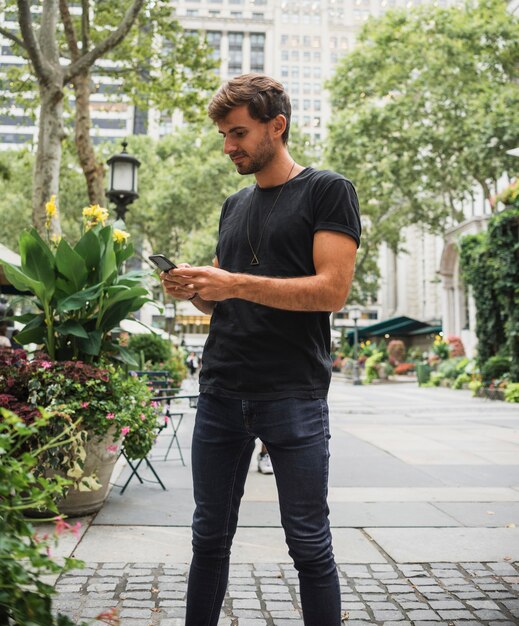 Young man typing on the phone