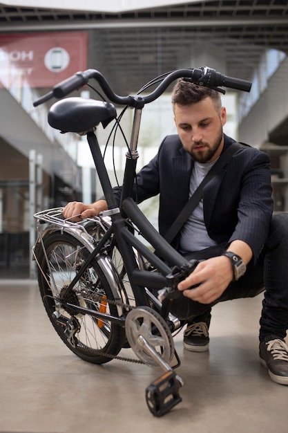 Young man using a folding bike in the city