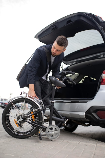 Young man using a folding bike in the city