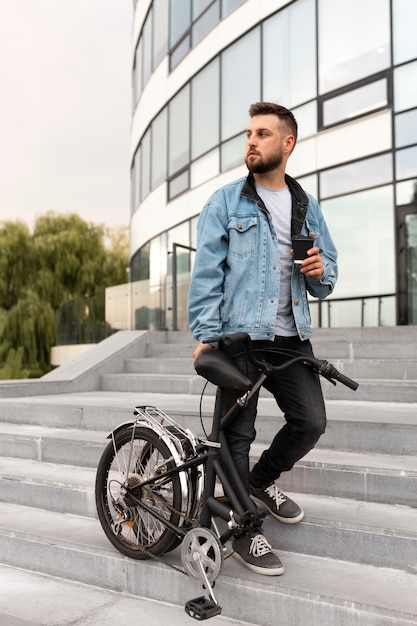 Young man using a folding bike in the city