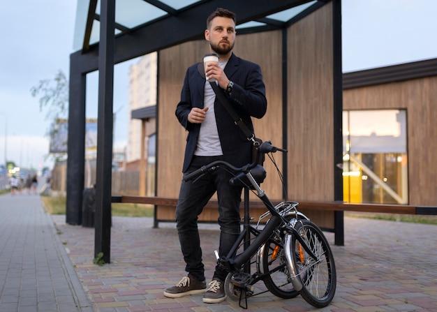 Young man using a folding bike in the city