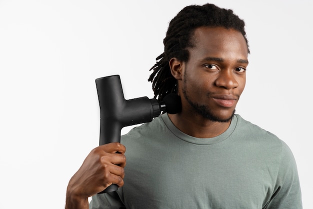 Young man using message gun