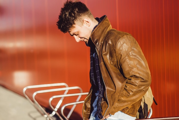 A young man walks around the city