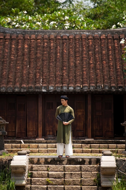 Free photo young man wearing ao dai costume