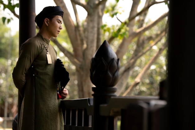 Free photo young man wearing ao dai costume