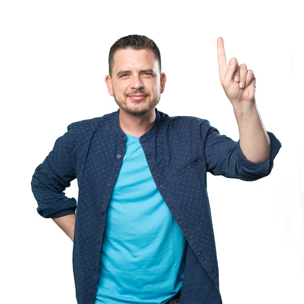 Young man wearing a blue outfit. Doing one number gesture.