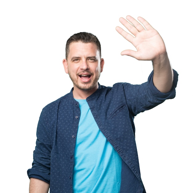 Free Photo young man wearing a blue outfit. greeting gesture.