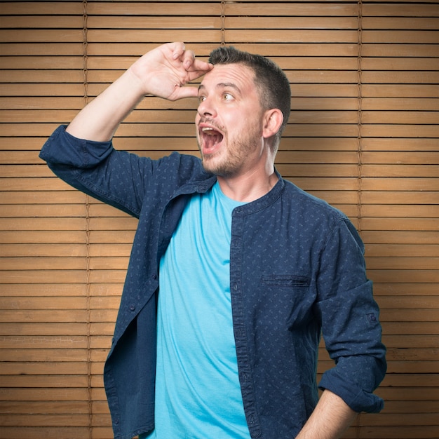 Young man wearing a blue outfit. Looking surprised.