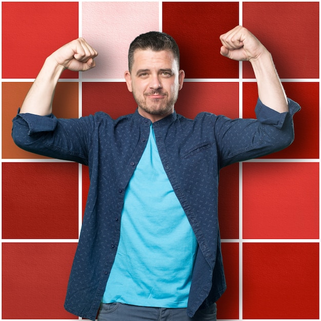 Free Photo young man wearing a blue outfit. showing muscle.