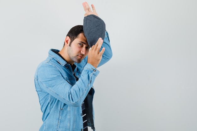 Free photo young man wearing cap in jacket,t-shirt front view. space for text