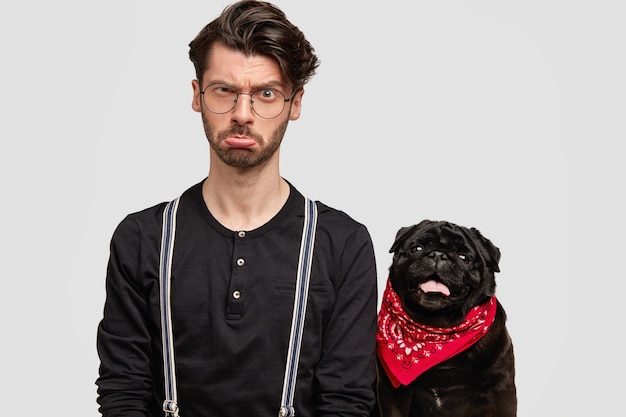 Free Photo young man wearing red bandana and black shirt and his dog