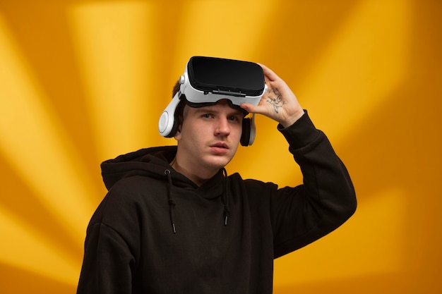 Free photo young man wearing virtual reality goggles on his head