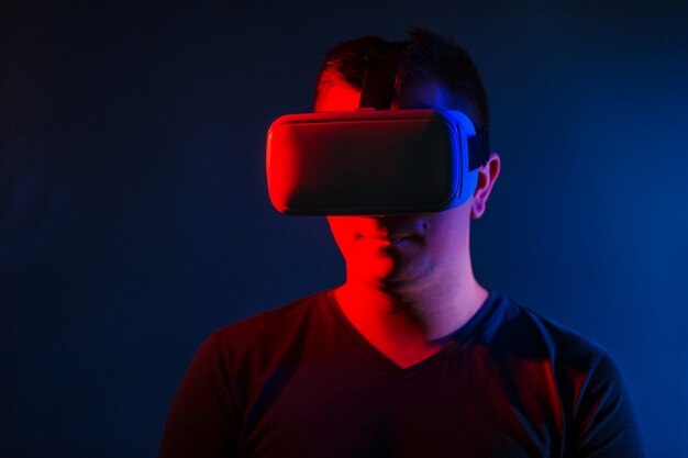 Young Man Wearing VR Headset And Experiencing Virtual Reality. 