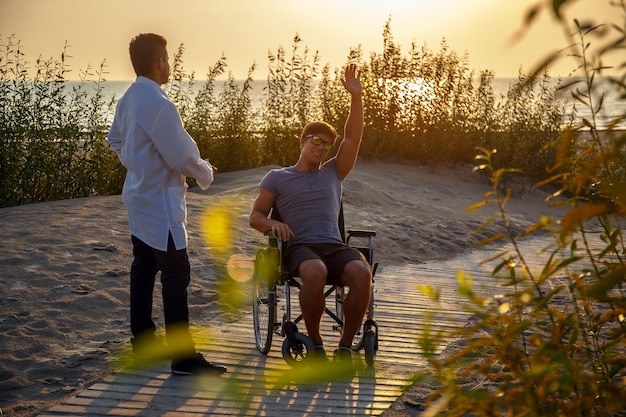 Free photo young man in wheelchair and his doctor.