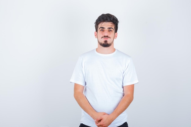 Young man in white t-shirt looking at front and looking confident