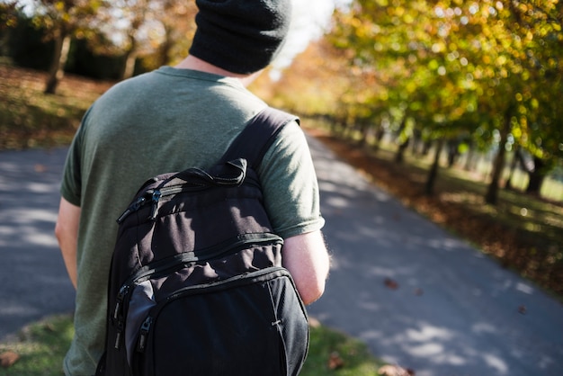 Free Photo young man with backpack in the park