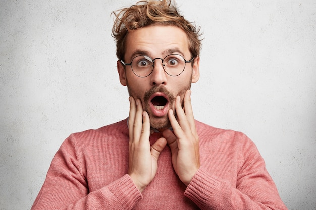 Young man with beard and round glasses