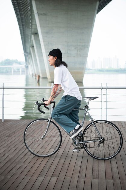 Young man with a bike in the city