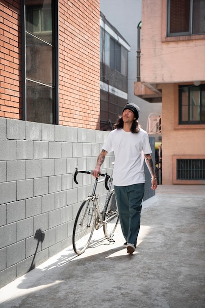 Young man with a bike in the city