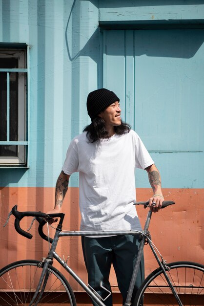 Young man with a bike in the city