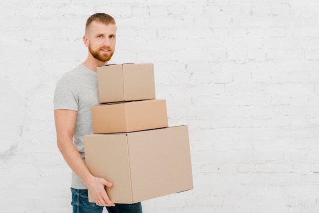 Free Photo young man with carton boxes