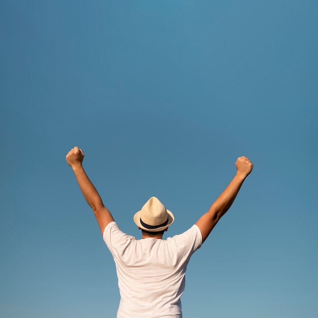 Young man with his arms in the air