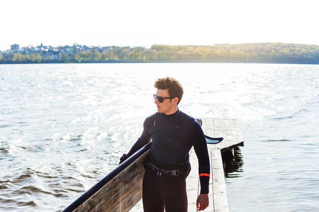 Young man with kitesurf board