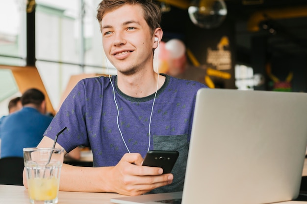 Free Photo young man with laptop and headphones