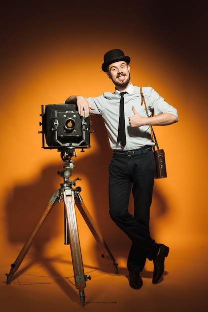 Young man with retro camera